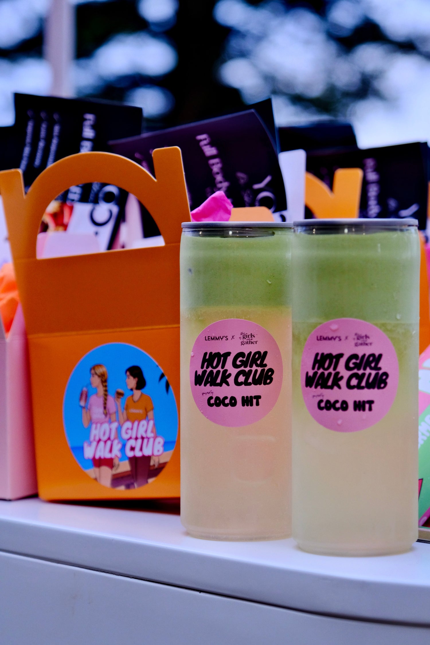 Two COCO HIT drinks with custom Hot Girl Walk Club branding at The Girls Who Gather community event. Refreshments provided for women attending the free Hot Girl Walk Club on the Central Coast, NSW.