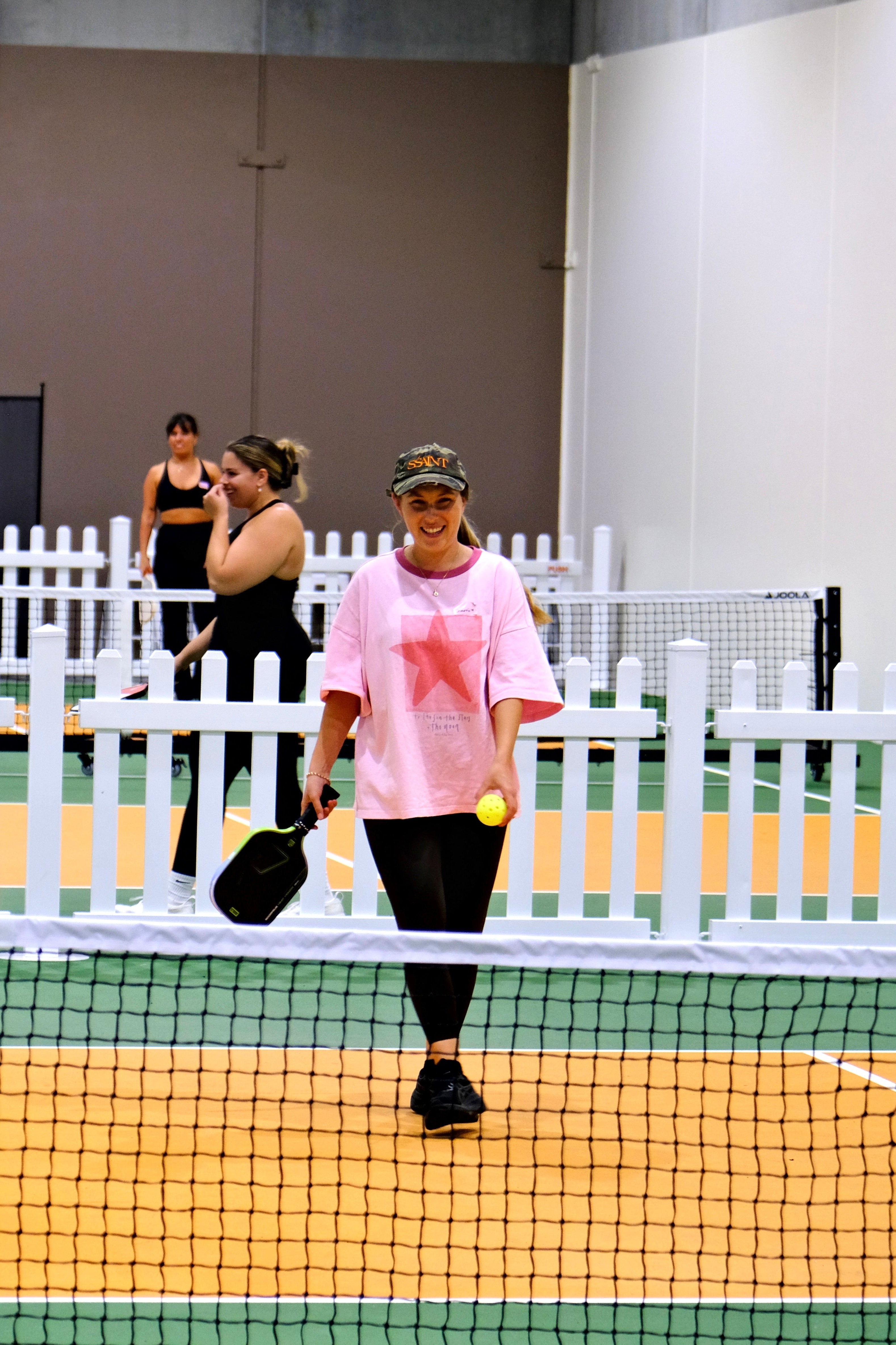 Woman playing pickleball at a beginner-friendly The Girls Who Gather social event at House of Pickle on the Central Coast. Community sports event designed to help women stay active, meet new people and build meaningful friendships.