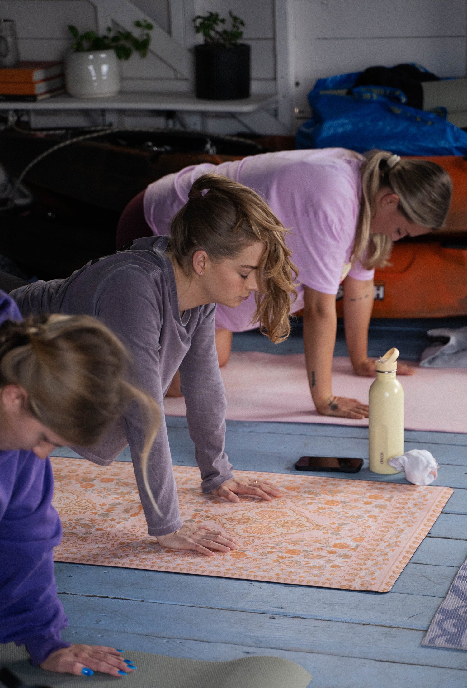 Women participating in a yoga class using Yogi Peace Club yoga mats at a The Girls Who Gather wellness event on the Central Coast.
